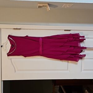 Women's dress. Fuscia color with rhinestone neckline and satin sash. Size 12.